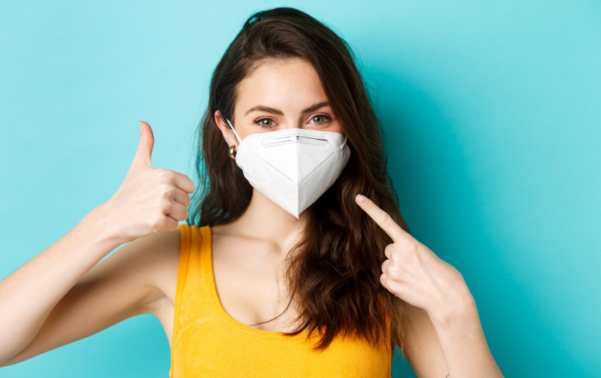 covid-19-coronavirus-social-distancing-wear-face-mask-smiling-woman-medical-respirator-pointing-face-showing-thumb-up-standing-blue-background.jpg